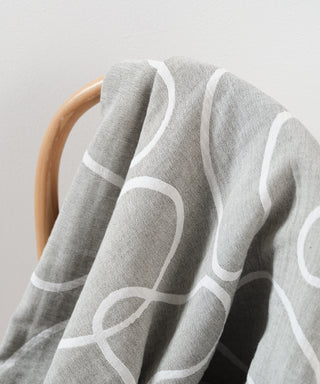 Patterned recycled cotton throw blanket on chair