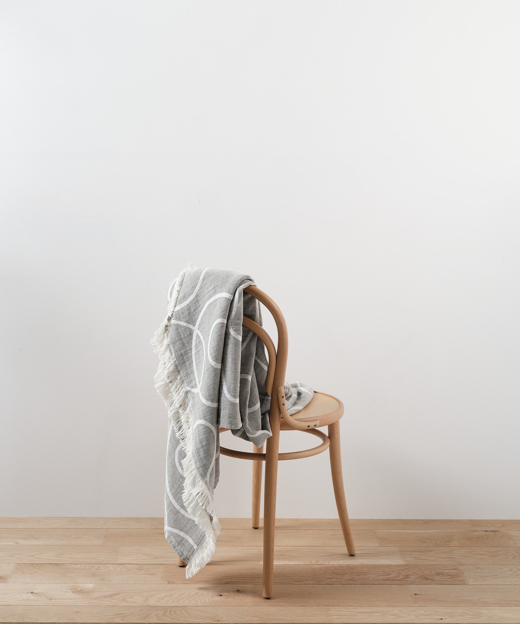 Patterned recycled cotton throw blanket on chair